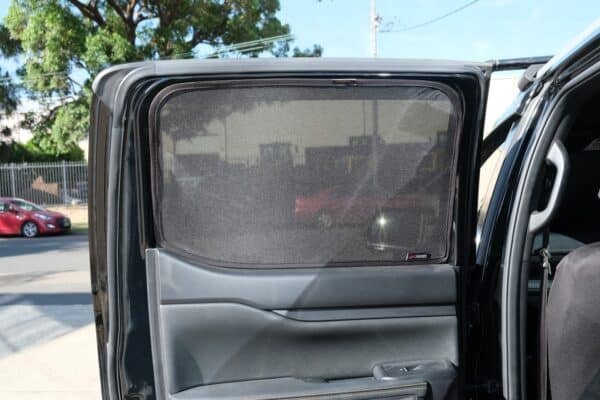 Rear passenger door of a Ford Ranger 4th generation with a custom-fit window sun shade installed, providing UV protection and privacy.