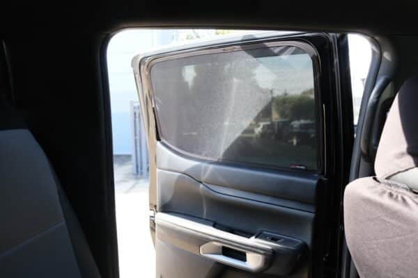 Rear passenger window of a Ford Ranger 4th generation fitted with a custom Snap Shades sun shade, offering UV protection and privacy.