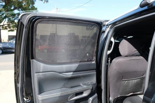 Rear passenger door of a Ford Ranger 4th generation with a custom-fit window sun shade installed, providing UV protection and privacy.