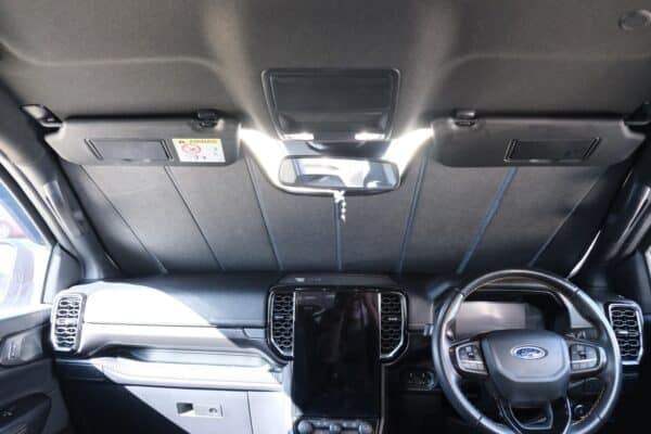 Interior view of a Ford Ranger 4th generation with a front windscreen shade installed, effectively blocking sunlight and protecting the dashboard.