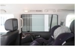 Interior view of a Nissan Patrol showcasing installed Snap Shades on the rear window, alongside a secured baby car seat.