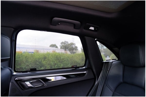 Interior view of a Porsche Macan with rear door sun shades installed.