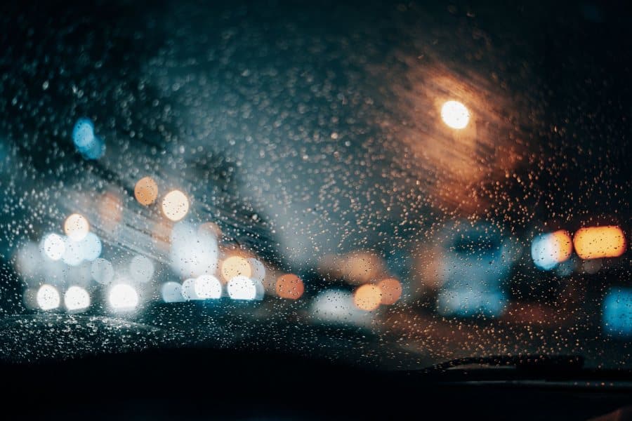 City lights through a rainy windscreen at night